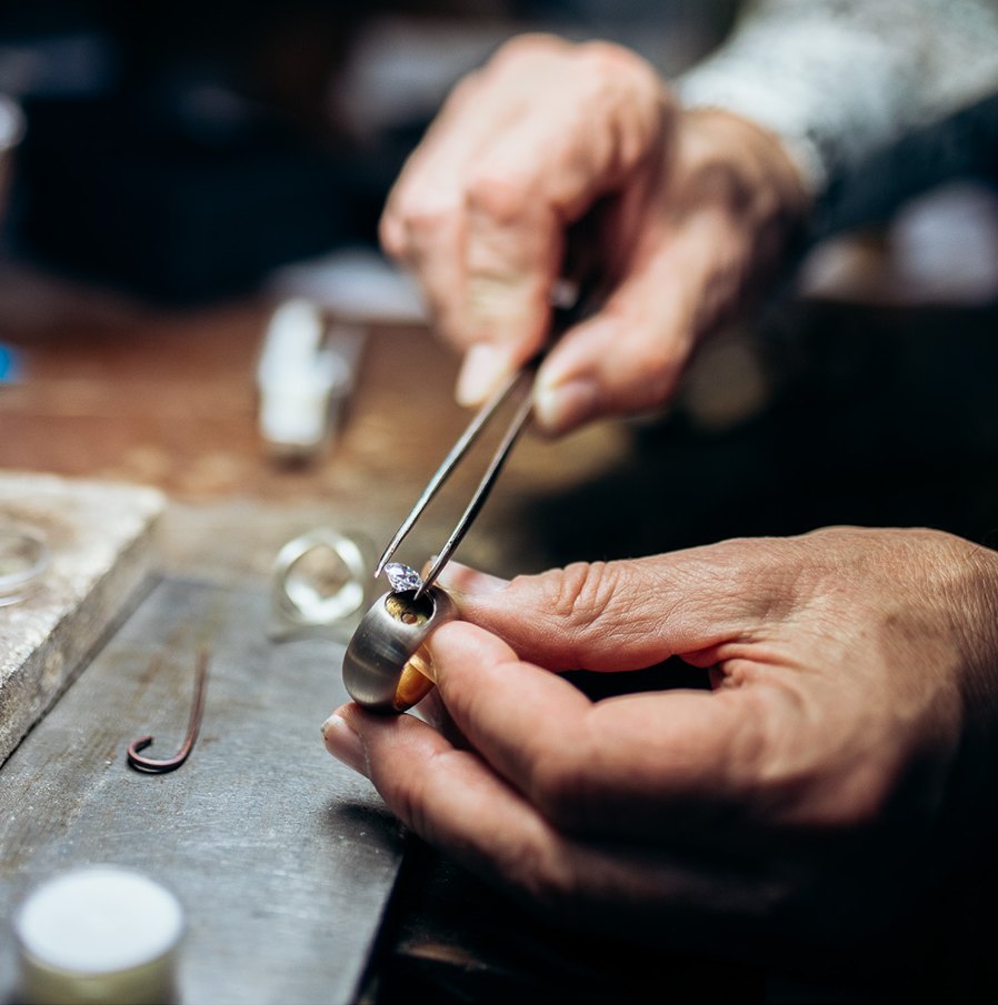 Hände eines Uhrmachers bei der Arbeit