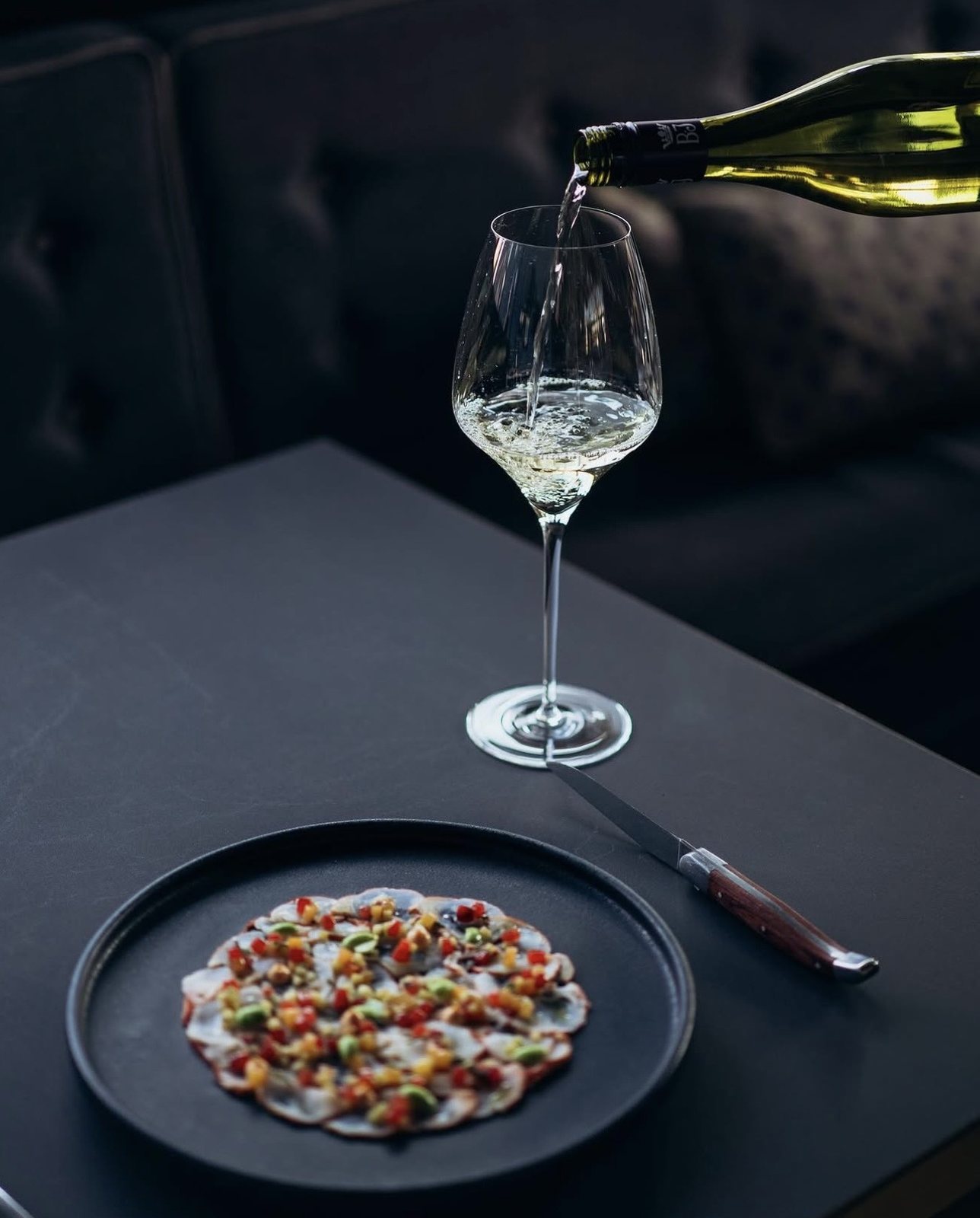Wein wird am Tisch eingeschenkt